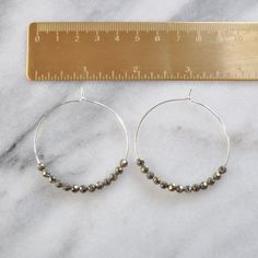 Libby & Smee Pyrite Beaded Earrings, still life with quarter for scale Earrings Gold Hoop, Woo Woo, Earring Card, Gold Filled Hoops, Hoop Earrings Gold, Earring Cards, Beaded Hoop Earrings, Sterling Silver Hoop Earrings, Large Earrings