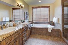 a large bathroom with two sinks and a bathtub