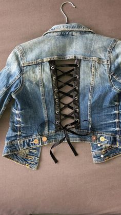 a jean jacket with laces on the back