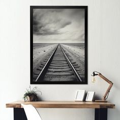 a black and white photo of a train track in the middle of an empty room