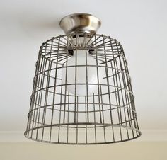 a caged light fixture hangs from the ceiling