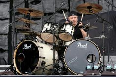 drummer playing drums on stage at an outdoor concert