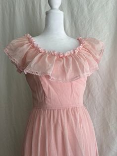 "This petite ruffled Prarie style bridesmaid dress was worn once for a wedding in 1981. It is in good vintage condition with two stains (pictured), a loose hem, and a few stray threads in the lining. There are belt loops sewn onto the waist, but the grosgrain ribbon is missing.  Measurements: Bust, taken flat PTP: 16\" Waist, taken flat: 11.5\" Hip, taken flat: 21.5\" Length, center of neckline to bottom of hem: 49\"" Elegant Vintage Ruffled Dress For Prom, Vintage Spring Prom Dresses, Spring Vintage Prom Dresses, Spring Wedding Vintage Dress With Ruffles, Feminine Ruffled Dresses For Vintage Events, Fitted Ruffle Vintage Dress For Prom, Fitted Vintage Ruffle Dress For Prom, Pink Sleeveless Vintage Dress With Ruffles, Vintage Sleeveless Bridesmaid Dresses