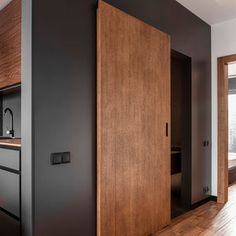 a blurry photo of a kitchen and living room in an apartment with wood paneling