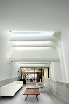 a living room filled with furniture and white walls