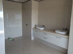 a bathroom with two sinks and mirrors in it