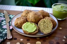 there are muffins on the plate and a cup of green tea