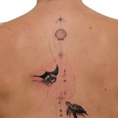 the back of a woman's neck with birds and shells on it