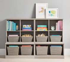 a book shelf with baskets and books on it