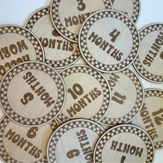 lots of personalized wooden name tags with checkerboard pattern and numbers on them