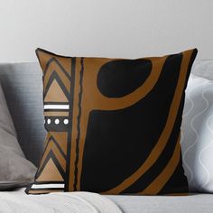 a brown and black pillow sitting on top of a couch