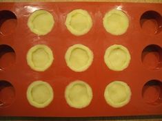 a red tray filled with cupcakes on top of a table