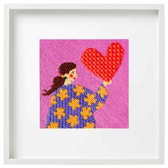 a cross stitch picture with a woman holding a heart in her hand, on a pink background