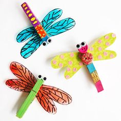 three dragonflys made out of construction paper