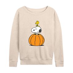 a white sweatshirt with a cartoon dog sitting on top of a pumpkin