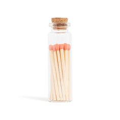 matches in a glass jar on a white background