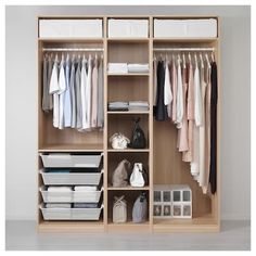 an open closet with clothes and other items on the shelves in front of white walls