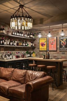 a leather couch sitting in front of a bar