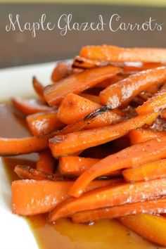 a white plate topped with carrots covered in sauce