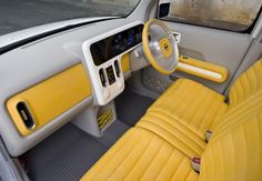 the interior of a car with yellow leather seats