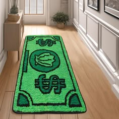 a green rug on the floor in a hallway