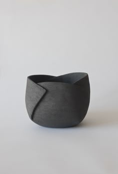 a black and white bowl sitting on top of a table