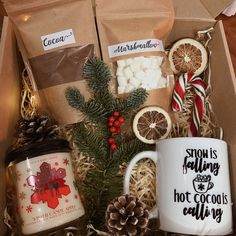 a christmas gift box filled with hot cocoa, marshmallows and orange slices