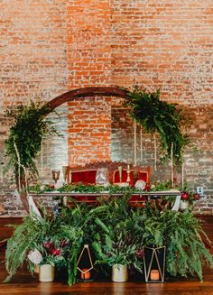 the table is set up with greenery and candles