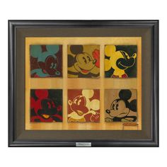 mickey mouse coasters are in a shadow box on the wall, with different colors and designs