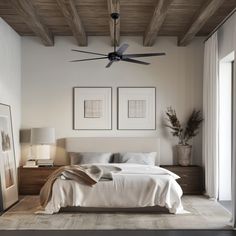 a bedroom with a large bed and two framed pictures on the wall next to it