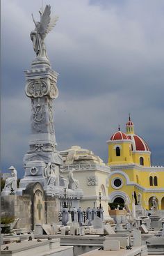 an old cemetery with a statue in the foreground