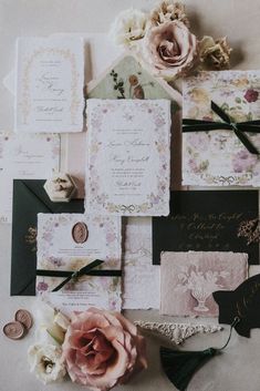 the wedding stationery is laid out on top of each other