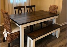 a dining room table with two benches next to it and a window in the background