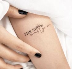 a woman's arm with the words, the show is over written on it