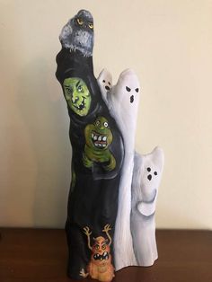 a group of ghost figurines sitting on top of a wooden table