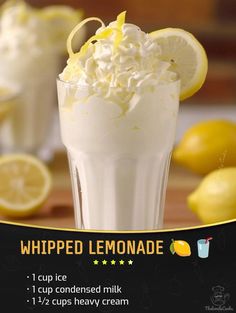 a lemonade drink with whipped cream and lemons in the background