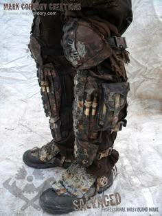 the legs and feet of a man in muddy gear