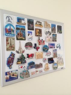 a white board with magnets and pictures on it