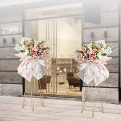 two bows with flowers on them are standing in front of a glass door that is open