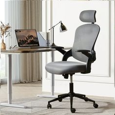 an office chair sitting next to a desk with a laptop on it