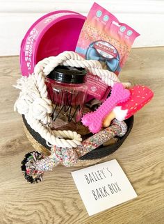 a basket filled with lots of items on top of a wooden floor next to a sign