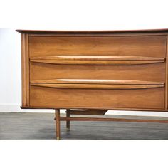 a wooden dresser sitting on top of a hard wood floor