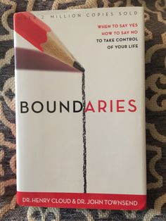 a book with a pencil sticking out of it's end and the title boundaries written in red