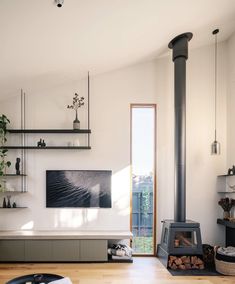 a living room filled with furniture and a fire place in front of a tv mounted on the wall