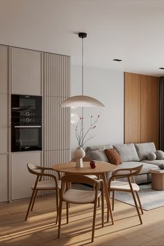 a living room filled with furniture and a wooden table in front of a large window