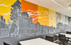 an empty room with tables and chairs in front of a large mural on the wall