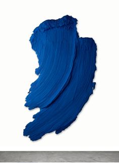 an abstract piece of art with blue paint