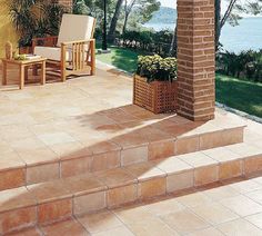 an outdoor patio with steps leading up to the water