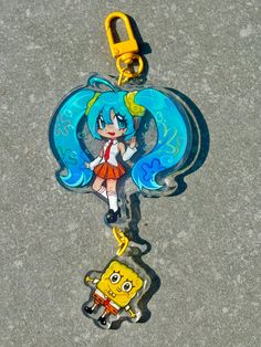 a keychain with a cartoon character hanging from it's side on the ground