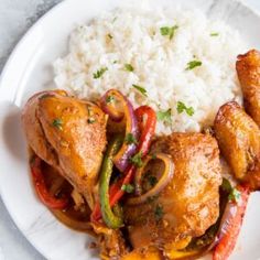 a white plate topped with chicken and rice